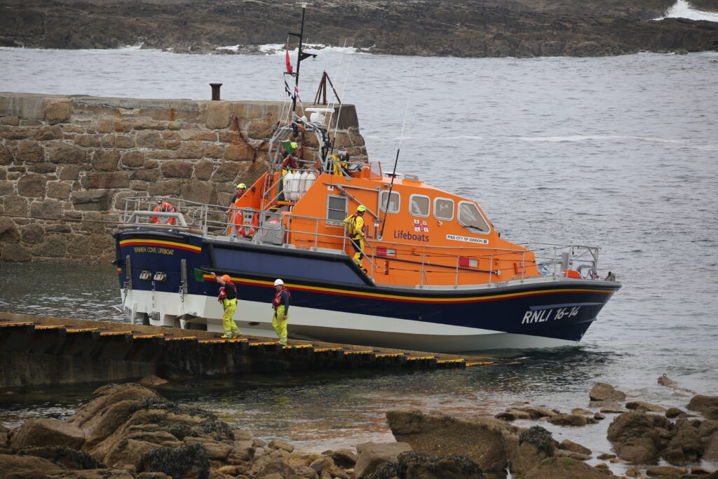 Lifeboat on the ramp being towed up by winch