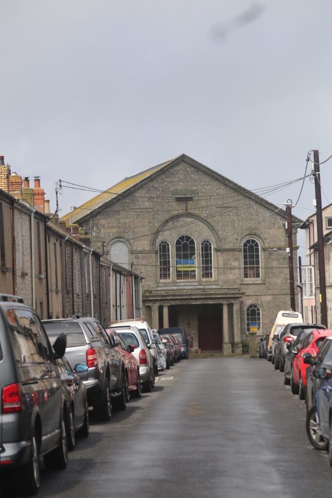 Street view leading up to a stone builing