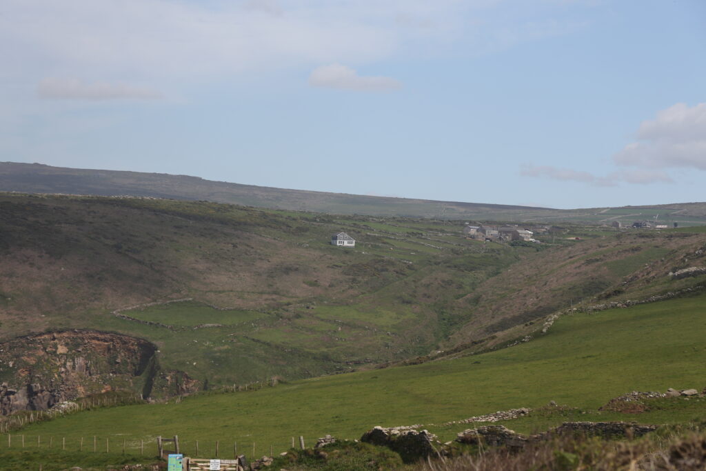 valley sparsely populated with houses in the distance